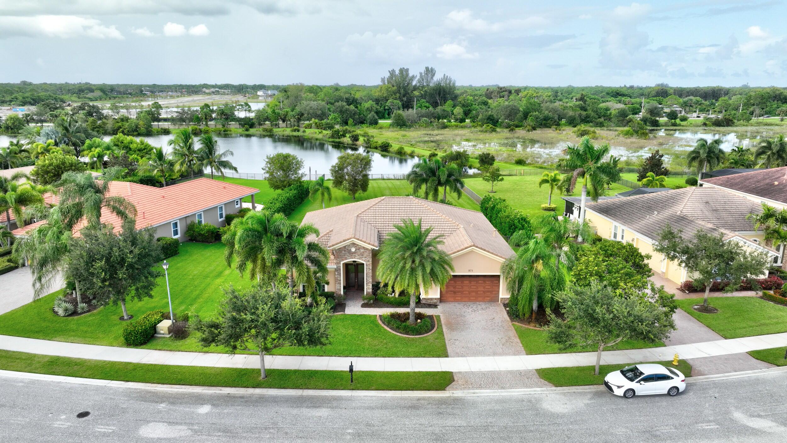 571 Southeast Tres Belle Circle Stuart, FL 34997 - Photo 44 of 54 a view of a garden with a swimming pool and outdoor space
