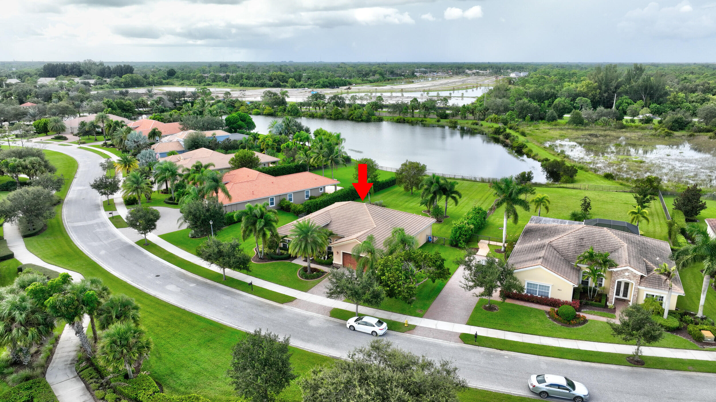 571 Southeast Tres Belle Circle Stuart, FL 34997 - Photo 46 of 54 an aerial view of city lake and houses with outdoor space