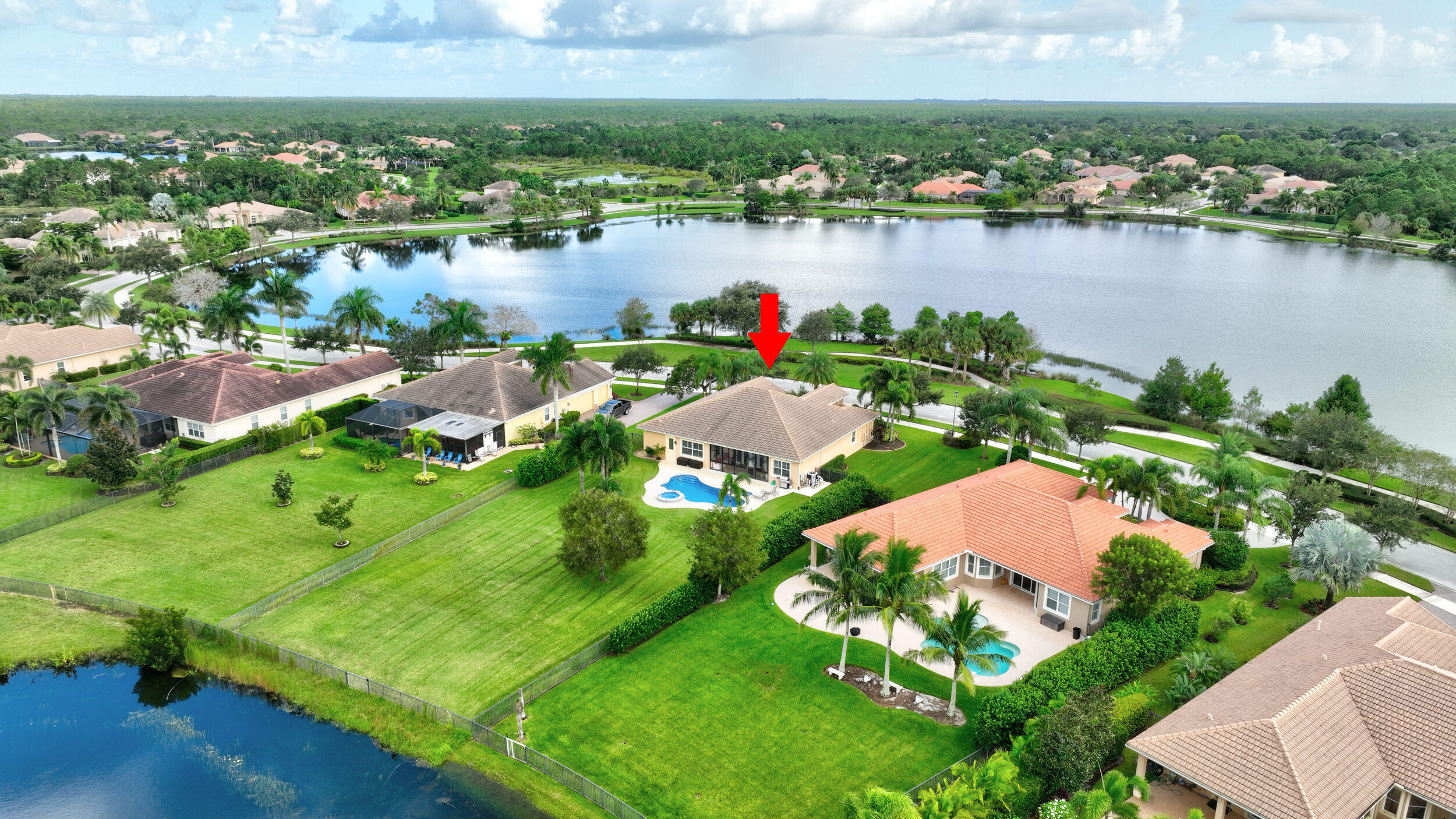 571 Southeast Tres Belle Circle Stuart, FL 34997 - Photo 48 of 54 an aerial view of lake residential houses with outdoor space and lake view
