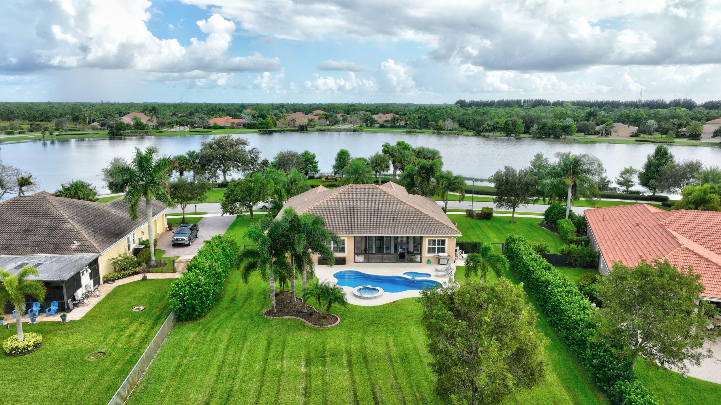 571 Southeast Tres Belle Circle Stuart, FL 34997 - Photo 53 of 54 a view of a lake with a yard