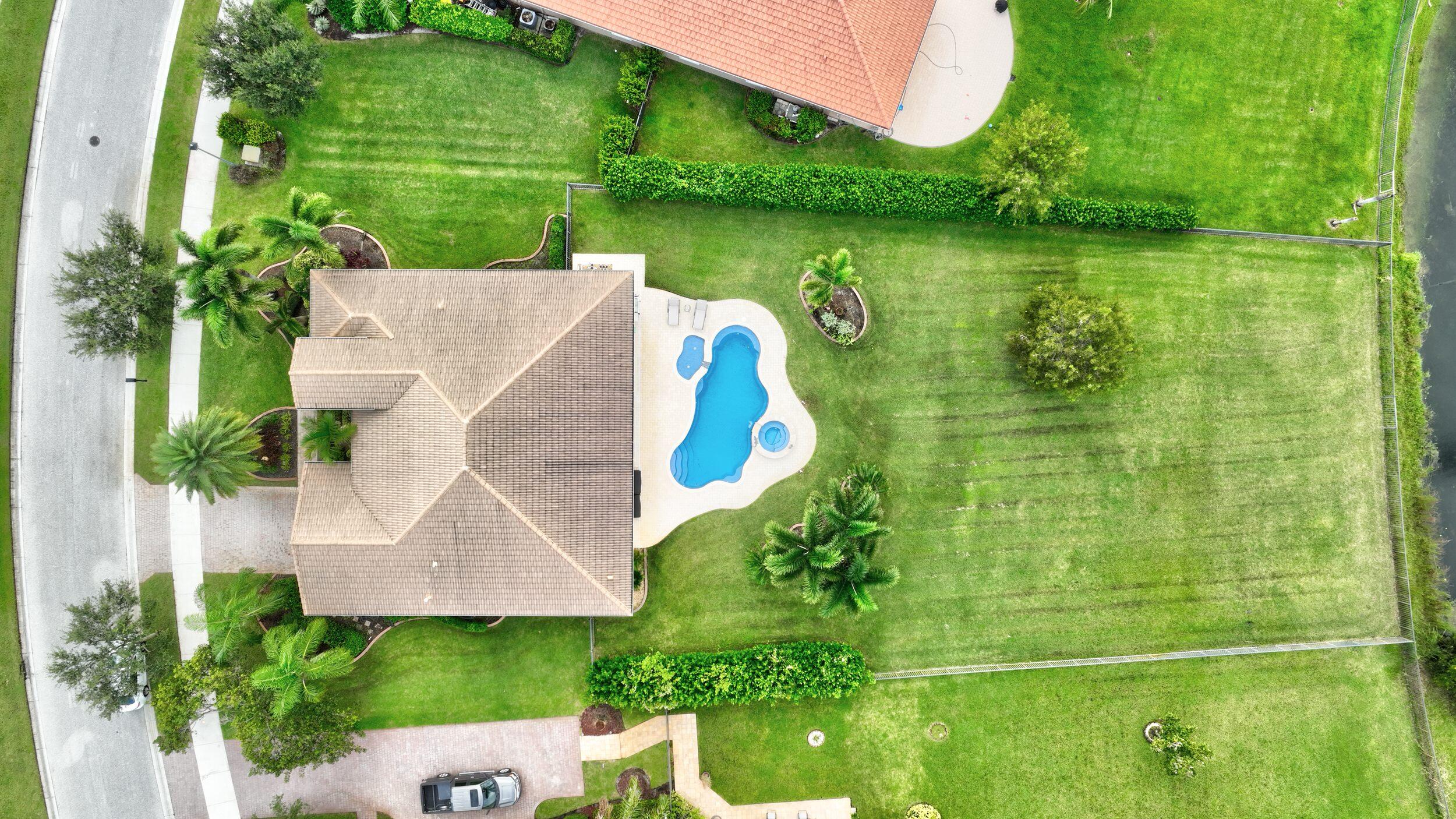 571 Southeast Tres Belle Circle Stuart, FL 34997 - Photo 54 of 54 an aerial view of a house with a garden and lake view