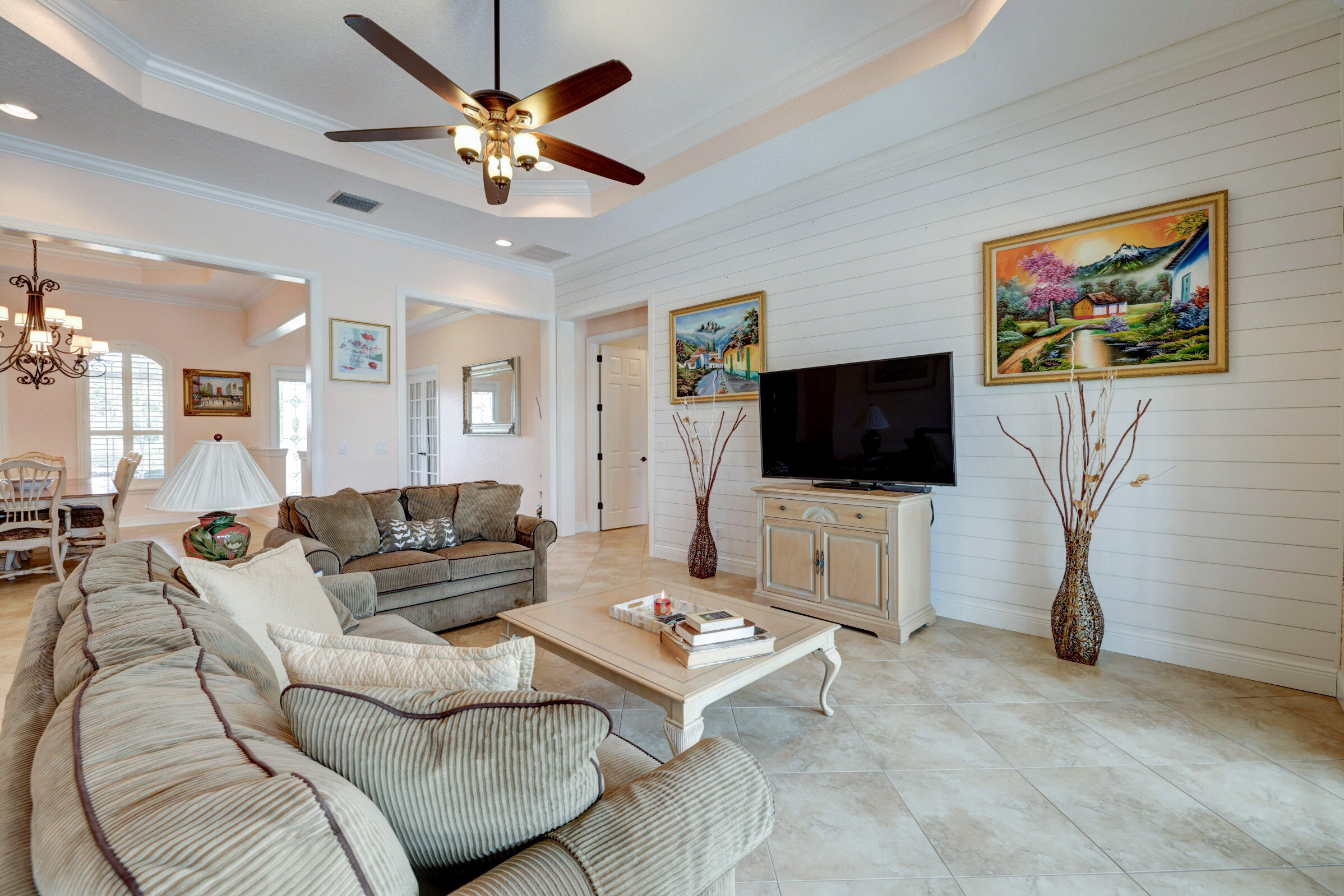 571 Southeast Tres Belle Circle Stuart, FL 34997 - Photo 9 of 54 a living room with furniture and a flat screen tv