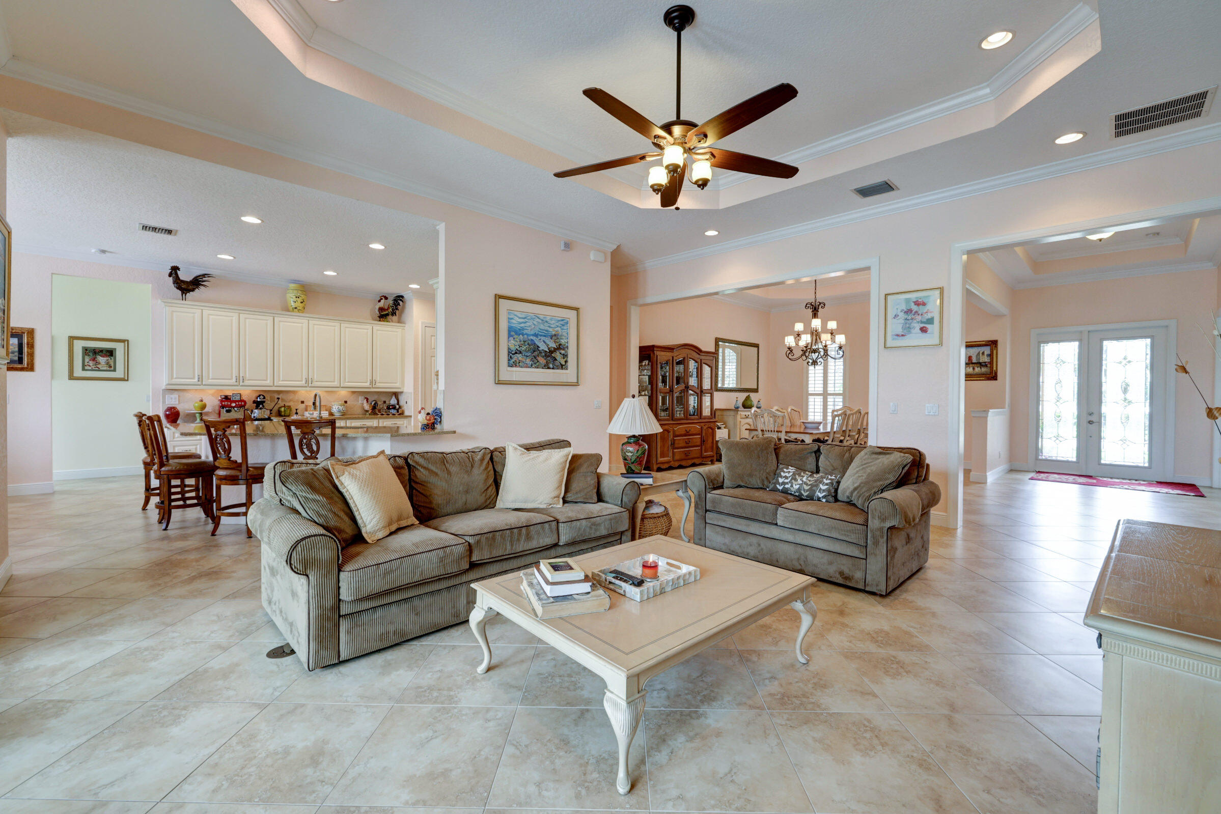 571 Southeast Tres Belle Circle Stuart, FL 34997 - Photo 10 of 54 a living room with furniture kitchen and a chandelier