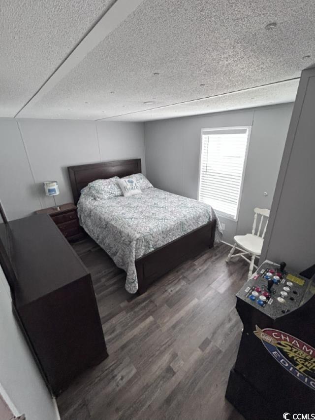 356 Calhoun Drive Murrells Inlet, SC 29576 - Photo 13 of 26 Bedroom featuring wood finished floors and a textured ceiling