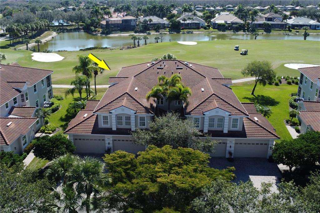 Aerial perspective of suburban area with a local golf course and a large body of water