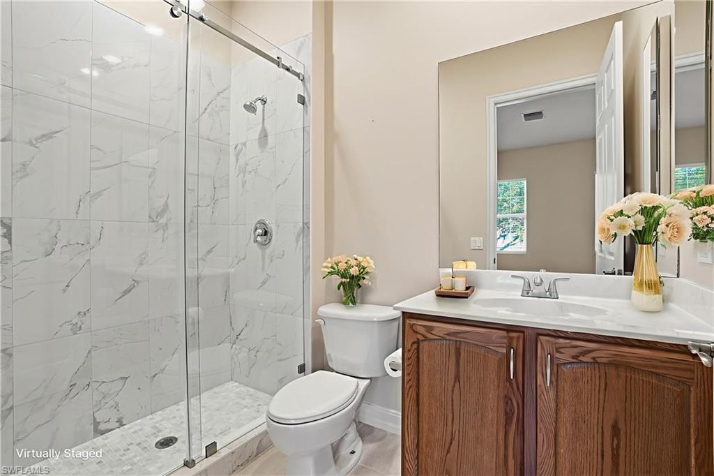 5963 Trophy Drive, Unit 2003 Naples, FL 34110 - Photo 11 of 50 Full bathroom featuring vanity and a marble finish shower