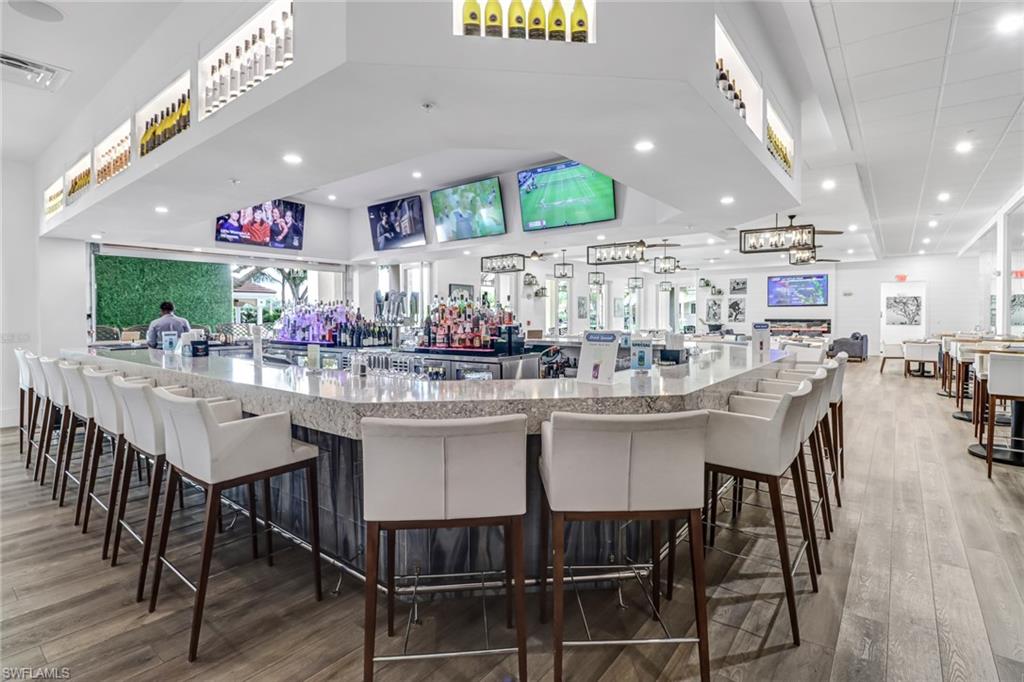 5963 Trophy Drive, Unit 2003 Naples, FL 34110 - Photo 21 of 50 Bar with light stone counters and recessed lighting