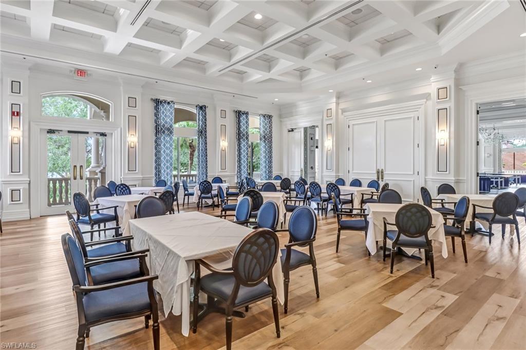 5963 Trophy Drive, Unit 2003 Naples, FL 34110 - Photo 22 of 50 Dining room with a decorative wall, light wood-type flooring, coffered ceiling, recessed lighting, and beam ceiling