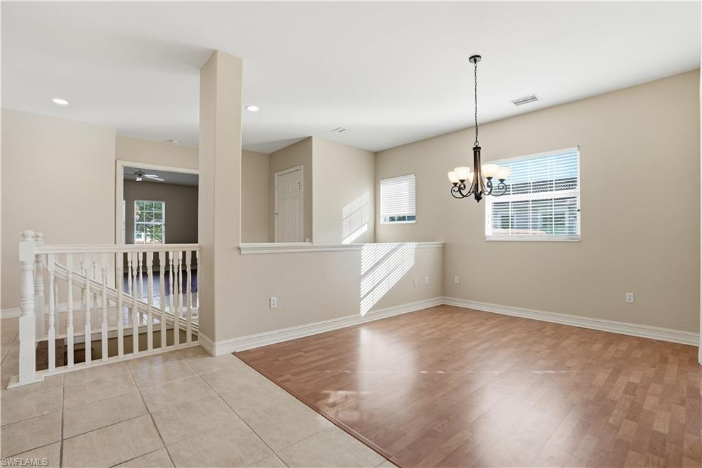5963 Trophy Drive, Unit 2003 Naples, FL 34110 - Photo 30 of 50 Empty room with light wood finished floors, recessed lighting, and a chandelier