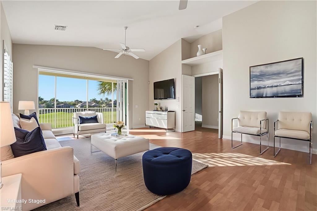 5963 Trophy Drive, Unit 2003 Naples, FL 34110 - Photo 3 of 50 Living room featuring wood finished floors, vaulted ceiling, and ceiling fan