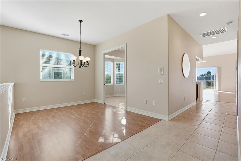 5963 Trophy Drive, Unit 2003 Naples, FL 34110 - Photo 31 of 50 Unfurnished dining area with light wood-style floors, plenty of natural light, a chandelier, and recessed lighting