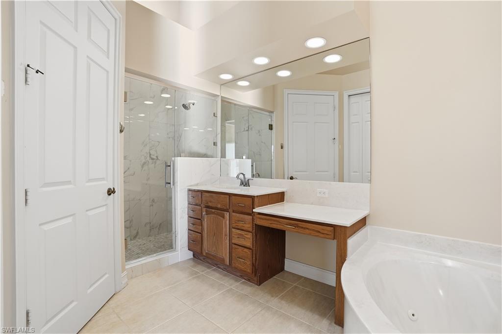 5963 Trophy Drive, Unit 2003 Naples, FL 34110 - Photo 34 of 50 Full bath featuring recessed lighting, vanity, a marble finish shower, a whirlpool tub, and light tile patterned floors