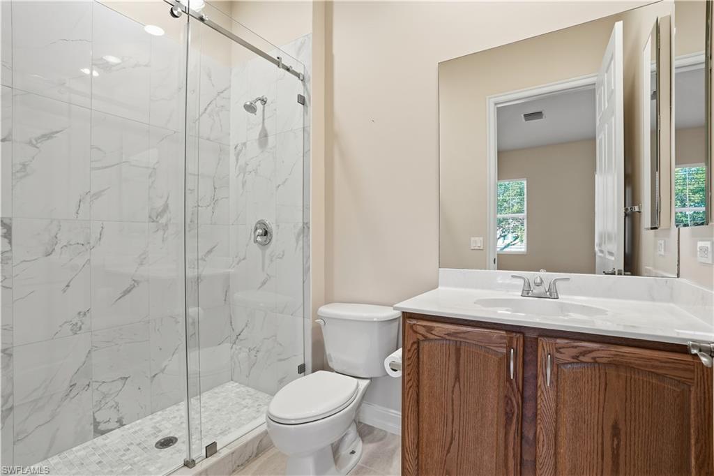 5963 Trophy Drive, Unit 2003 Naples, FL 34110 - Photo 41 of 50 Full bathroom with vanity, a marble finish shower, and light tile patterned flooring