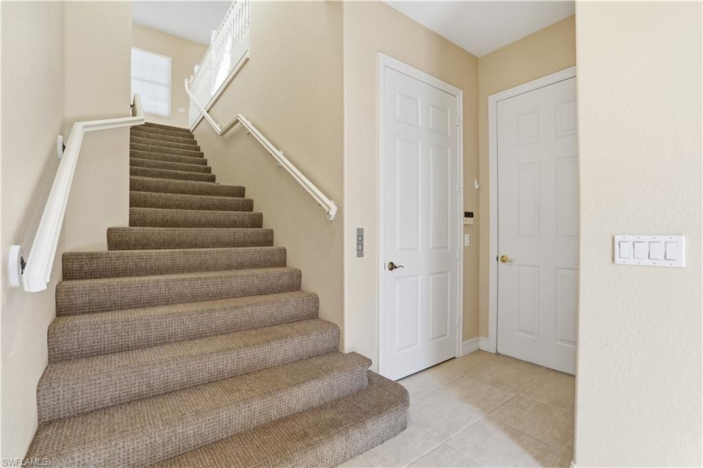 5963 Trophy Drive, Unit 2003 Naples, FL 34110 - Photo 44 of 50 Stairs with tile patterned flooring