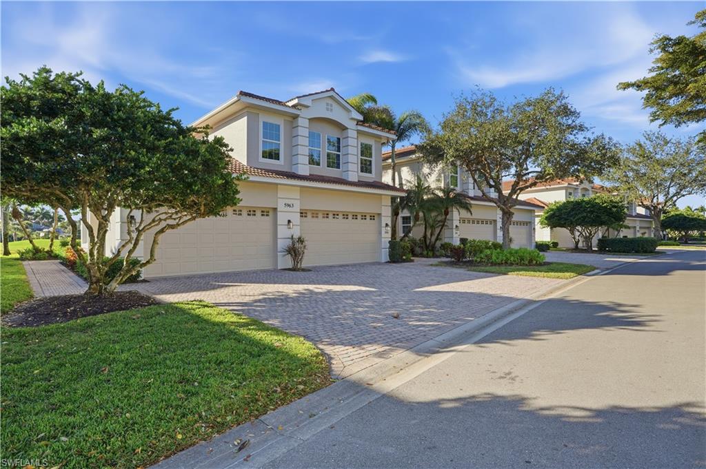 5963 Trophy Drive, Unit 2003 Naples, FL 34110 - Photo 50 of 50 Mediterranean / spanish-style home with decorative driveway, stucco siding, an attached garage, and a tiled roof