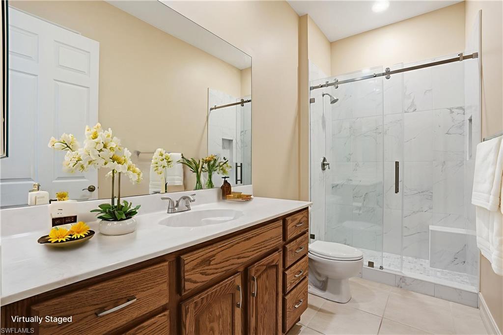 5963 Trophy Drive, Unit 2003 Naples, FL 34110 - Photo 9 of 50 Full bathroom with vanity, a marble finish shower, and light tile patterned floors