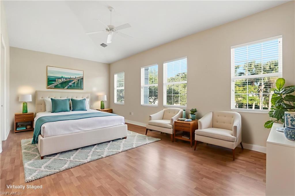 5963 Trophy Drive, Unit 2003 Naples, FL 34110 - Photo 10 of 50 Bedroom featuring a ceiling fan, wood finished floors, and vaulted ceiling