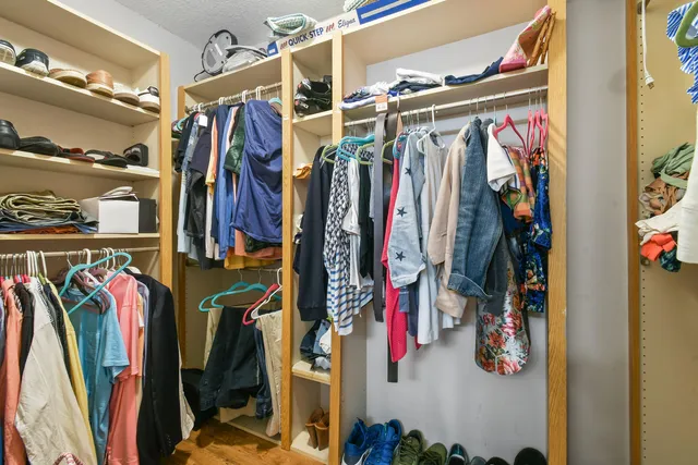 a view of walk in closet with clothes