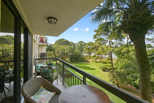 a view of a chairs and table in the balcony