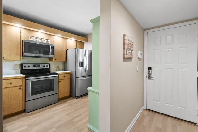 a kitchen with a refrigerator stove and microwave