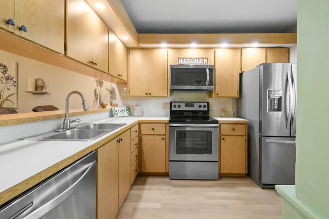 a kitchen with a refrigerator sink and stove