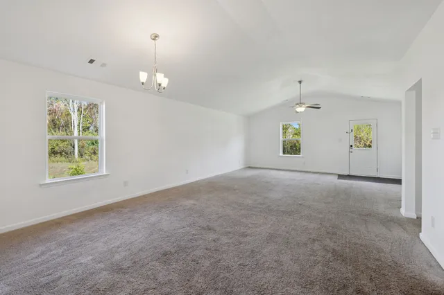 an empty room with windows and closet