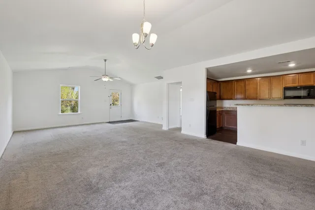 a view of a kitchen with a sink and a chandelier