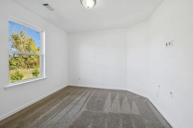 a view of room with window and ceiling fan