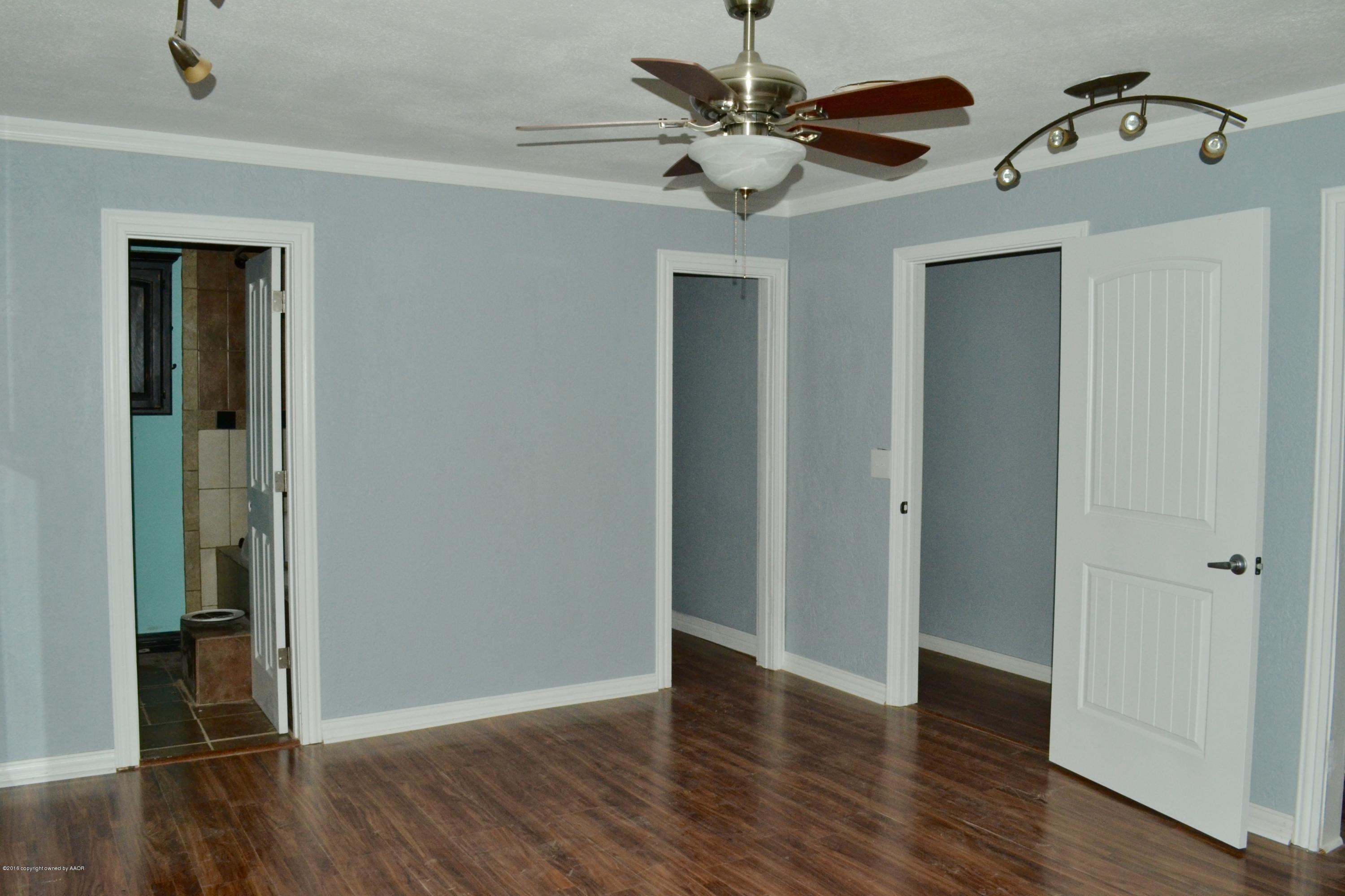 4004 South Lipscomb Street Amarillo, TX 79110 - Photo 13 of 49 an empty room with wooden floor fan and windows