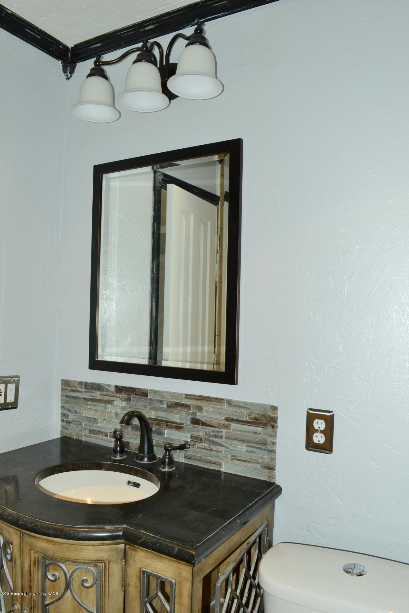 4004 South Lipscomb Street Amarillo, TX 79110 - Photo 40 of 49 a bathroom with a sink and a mirror