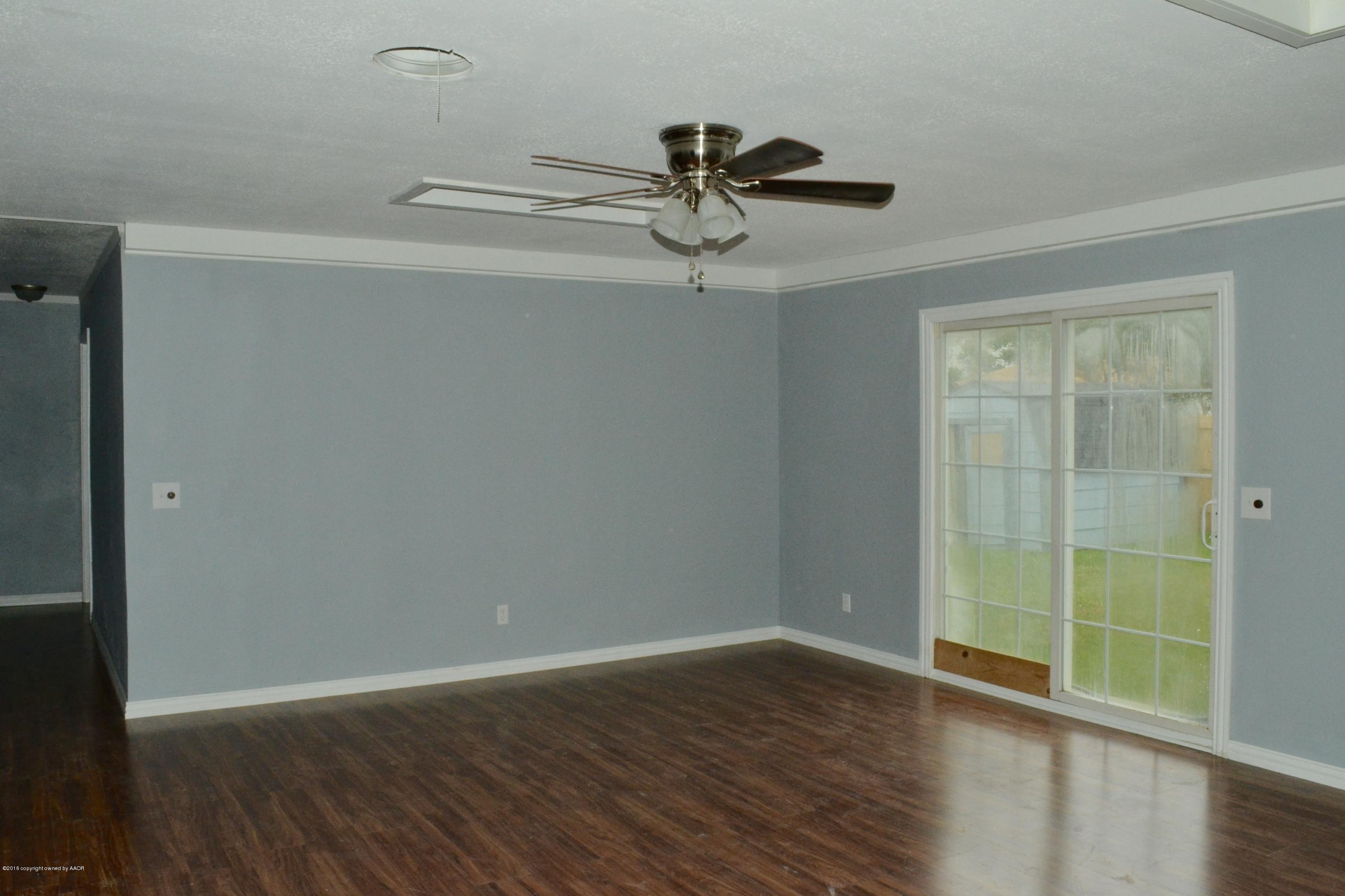 4004 South Lipscomb Street Amarillo, TX 79110 - Photo 9 of 49 a view of an empty room with wooden floor and a window