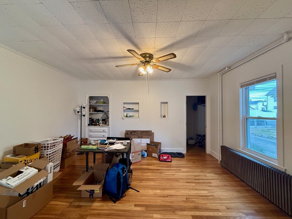 56 Lincoln Road, Unit 56 Newton, MA 02458 - Photo 3 of 10 a living room with furniture and wooden floor