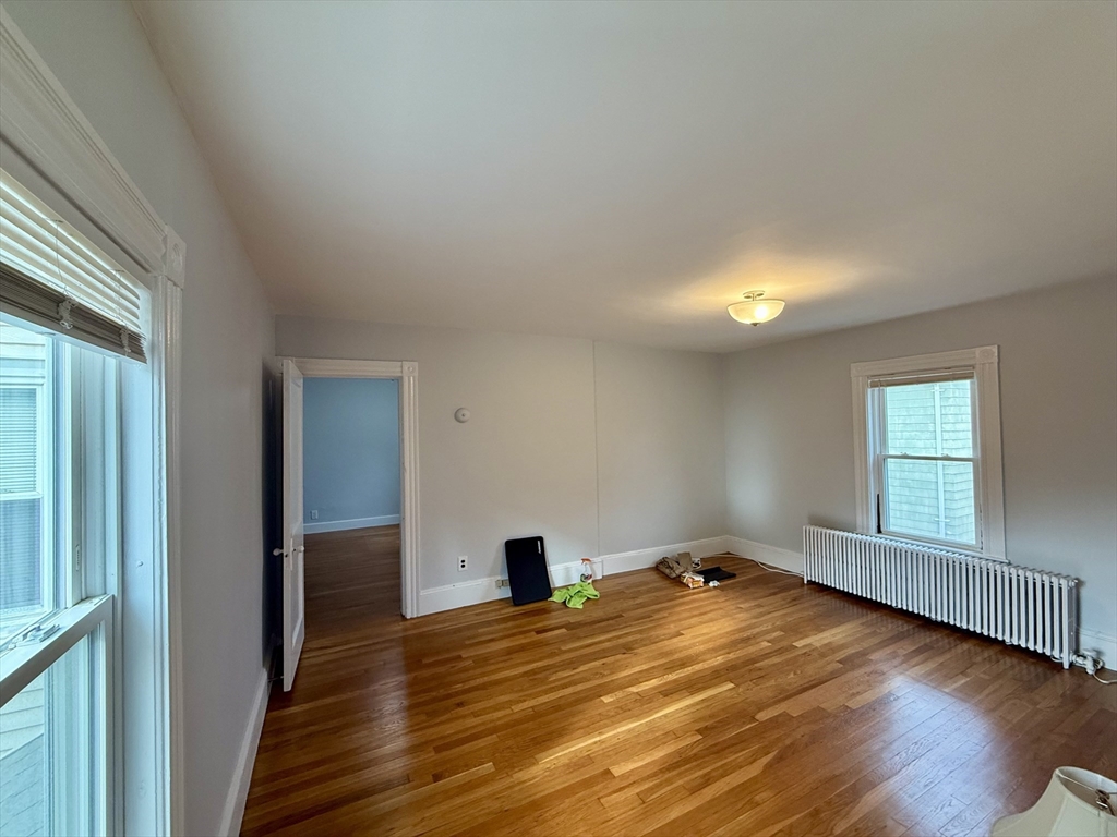 56 Lincoln Road, Unit 56 Newton, MA 02458 - Photo 6 of 10 a view of empty room with wooden floor