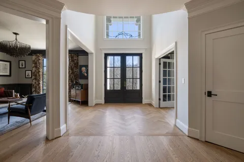 a kitchen with a dining table chairs stove and white cabinets