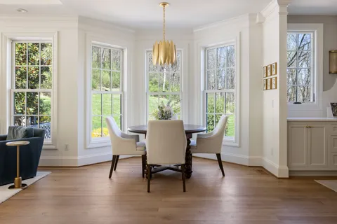 a bathroom with a double vanity sink a mirror and next to a window