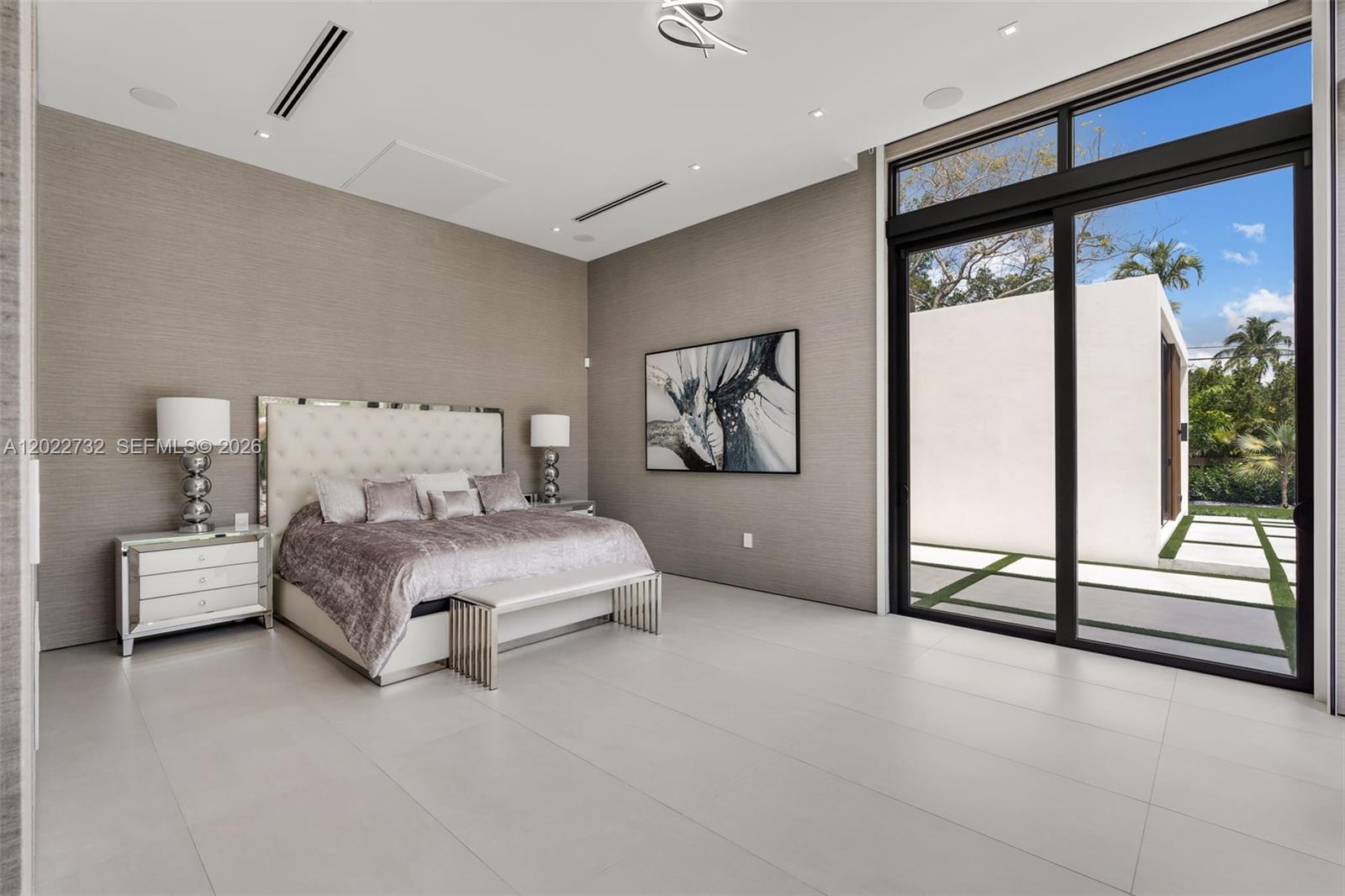 7825 Southwest 128th Street Pinecrest, FL 33156 - Photo 22 of 88 a bedroom with a large bed and a large window