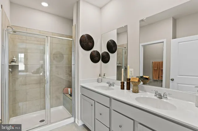 a bathroom with a shower sink and mirror