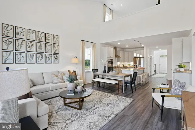 a living room with furniture wooden floor and a table