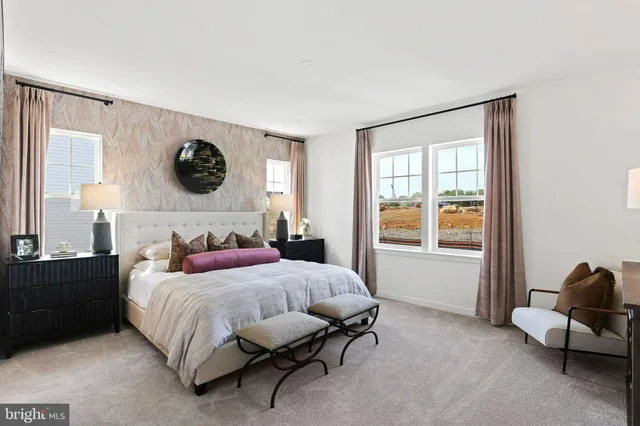 a bedroom with a bed a table and chair