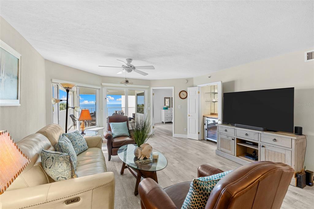 16332 Gulf Boulevard, Unit 2B Redington Beach, FL 33708 - Photo 14 of 60 a living room with furniture and a flat screen tv