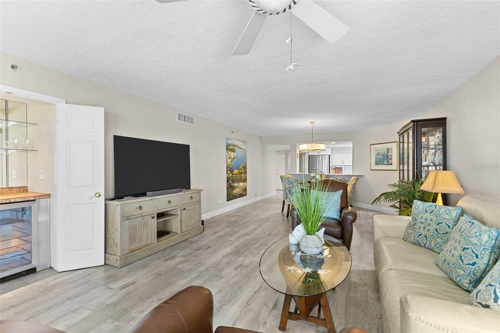 16332 Gulf Boulevard, Unit 2B Redington Beach, FL 33708 - Photo 17 of 60 a living room with furniture and a flat screen tv