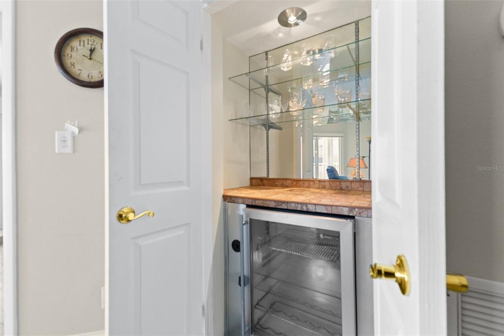 16332 Gulf Boulevard, Unit 2B Redington Beach, FL 33708 - Photo 18 of 60 a bathroom with a granite countertop sink a mirror and a shower