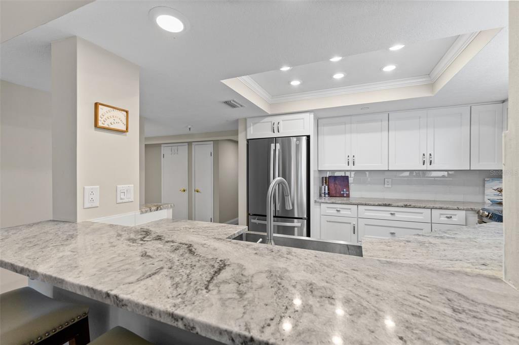 16332 Gulf Boulevard, Unit 2B Redington Beach, FL 33708 - Photo 22 of 60 a view of kitchen with refrigerator stove and cabinets