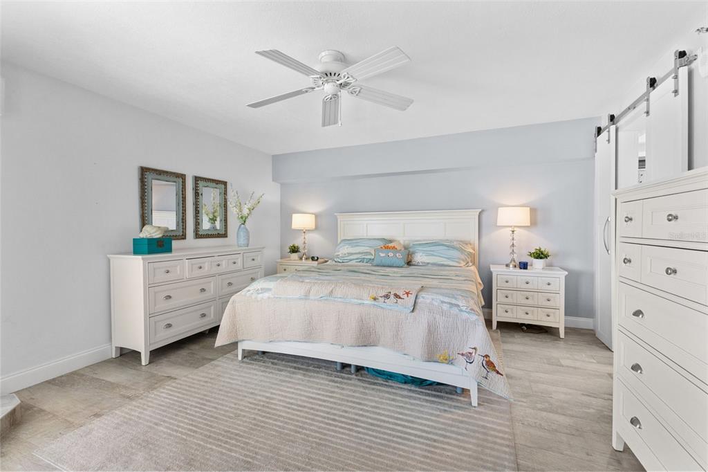 16332 Gulf Boulevard, Unit 2B Redington Beach, FL 33708 - Photo 27 of 60 a bedroom with a bed and a dresser