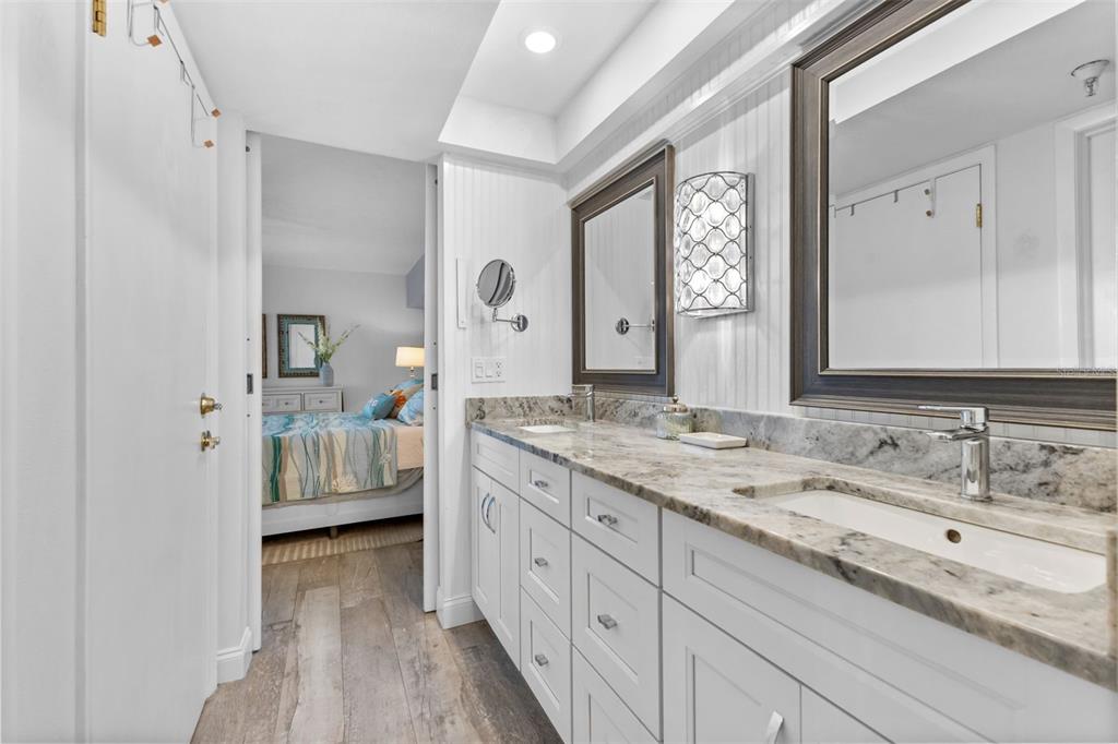 16332 Gulf Boulevard, Unit 2B Redington Beach, FL 33708 - Photo 29 of 60 a en suite bathroom with a double vanity sink and a mirror