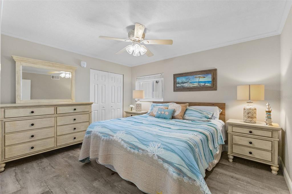 16332 Gulf Boulevard, Unit 2B Redington Beach, FL 33708 - Photo 31 of 60 a bedroom with a bed and a dresser