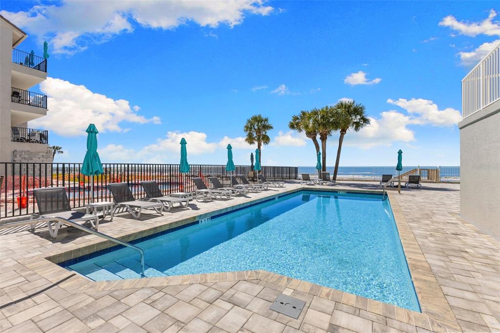 16332 Gulf Boulevard, Unit 2B Redington Beach, FL 33708 - Photo 45 of 60 a view of a swimming pool and lounge chairs