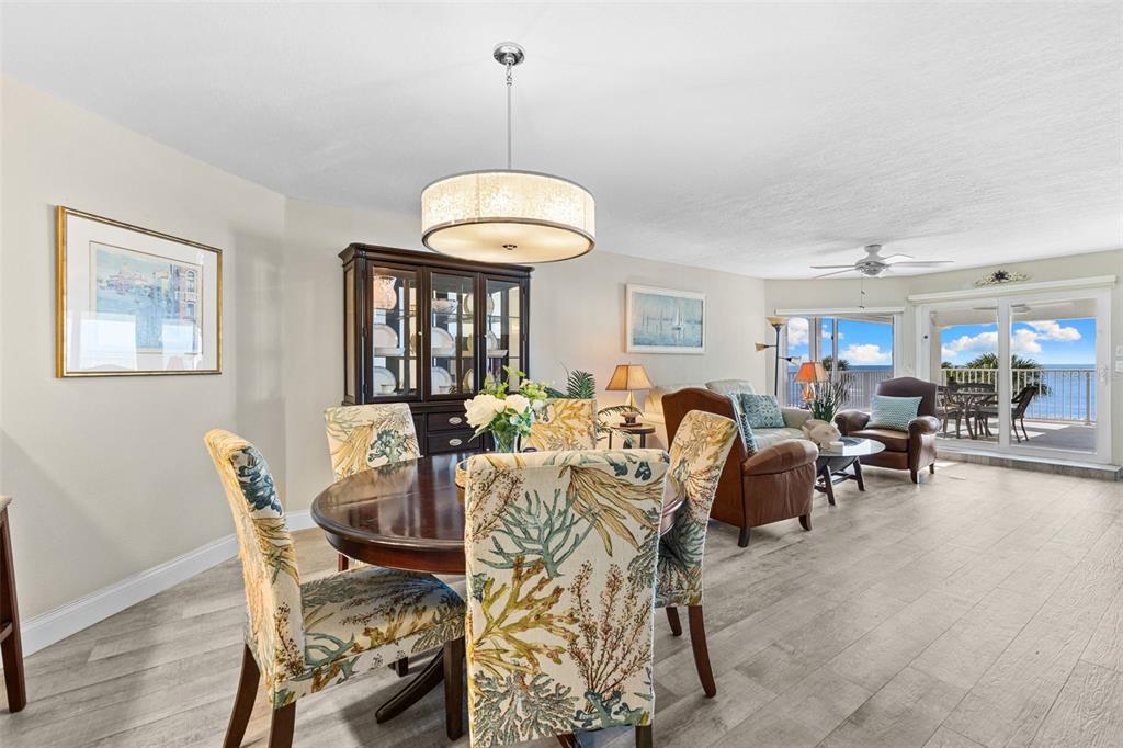 16332 Gulf Boulevard, Unit 2B Redington Beach, FL 33708 - Photo 10 of 60 a view of a dining room and livingroom with furniture wooden floor a chandelier