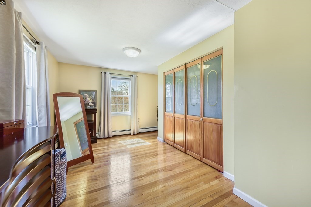 322 Wolf Swamp Road Longmeadow, MA 01106 - Photo 18 of 24 a view of a hallway with furniture and wooden floor