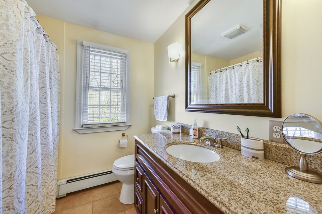 322 Wolf Swamp Road Longmeadow, MA 01106 - Photo 19 of 24 a bathroom with a granite countertop sink a mirror and a toilet